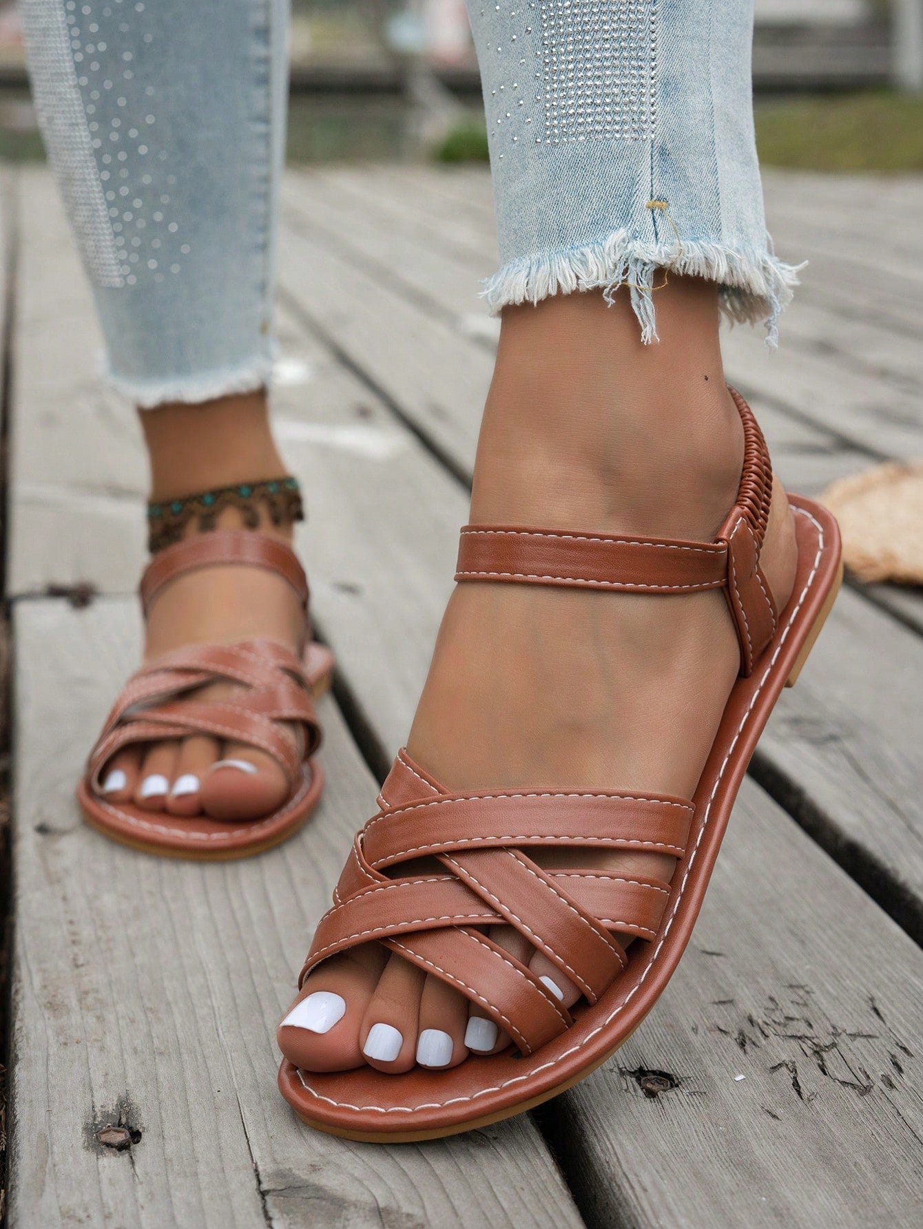 Women's flat thick sole gladiator sandals with cross adjustable straps and open toe, suitable for casual, vacation, and beach wear.
