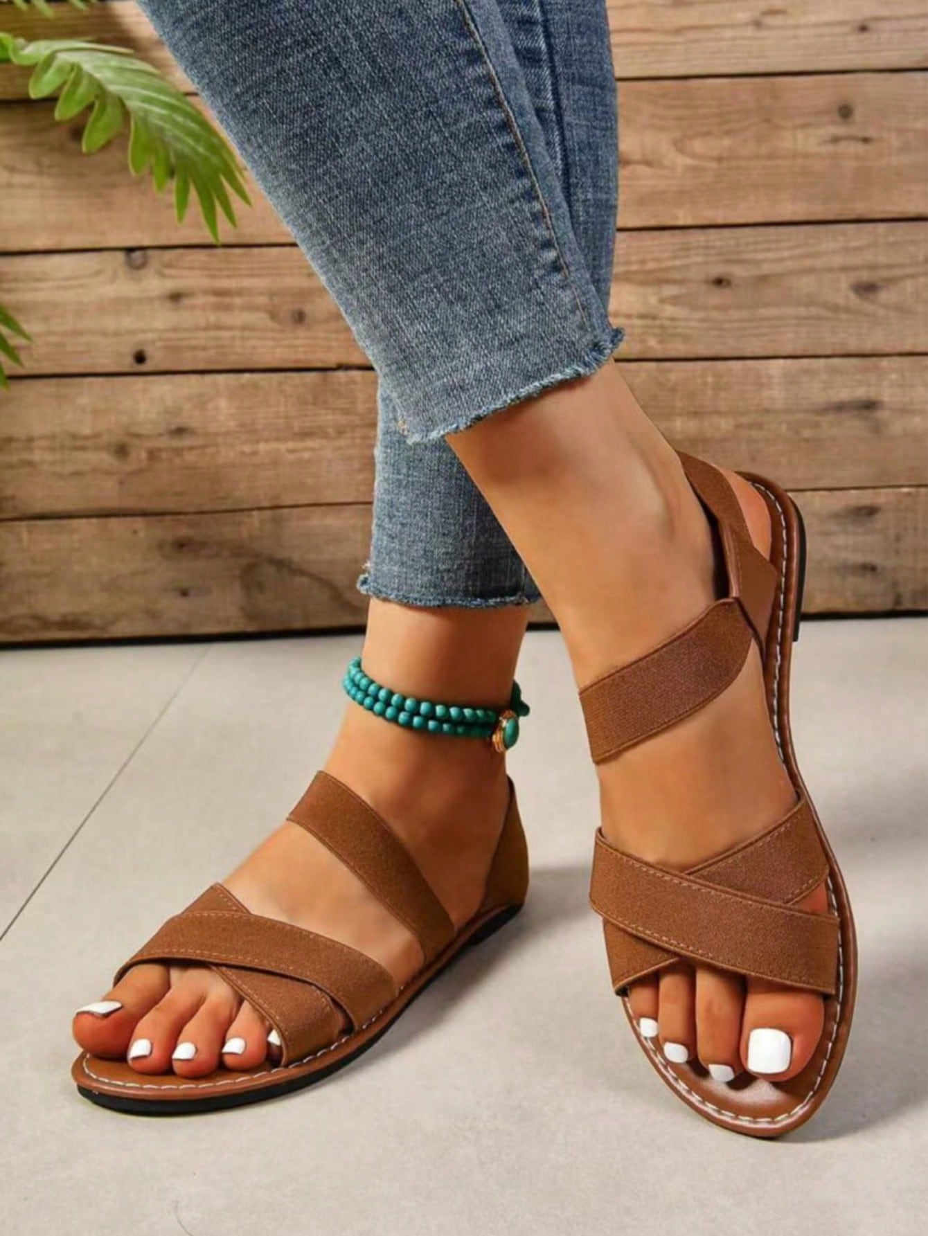 Women's flat thick sole gladiator sandals with cross adjustable straps and open toe, suitable for casual, vacation, and beach wear.