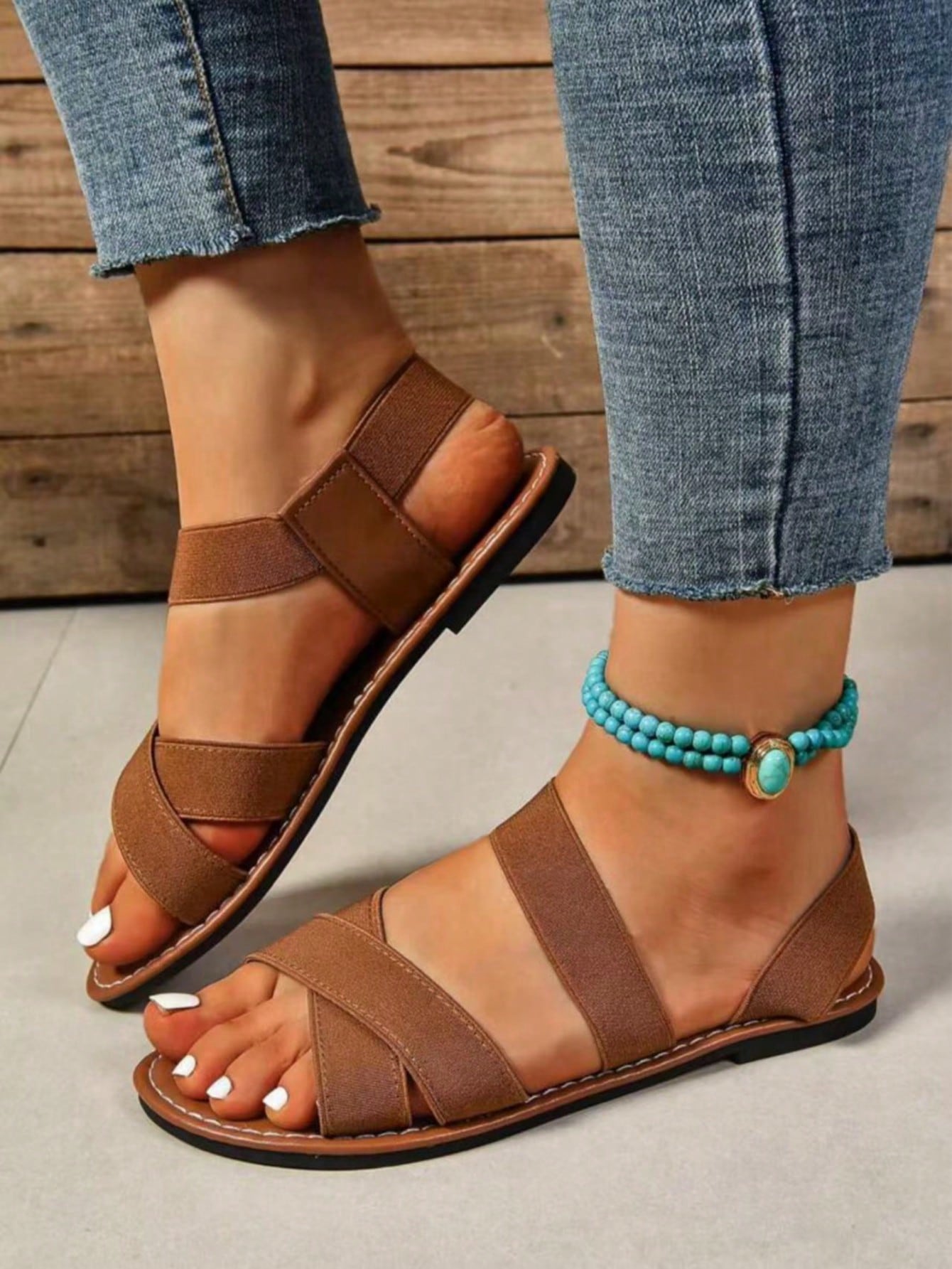 Women's flat thick sole gladiator sandals with cross adjustable straps and open toe, suitable for casual, vacation, and beach wear.