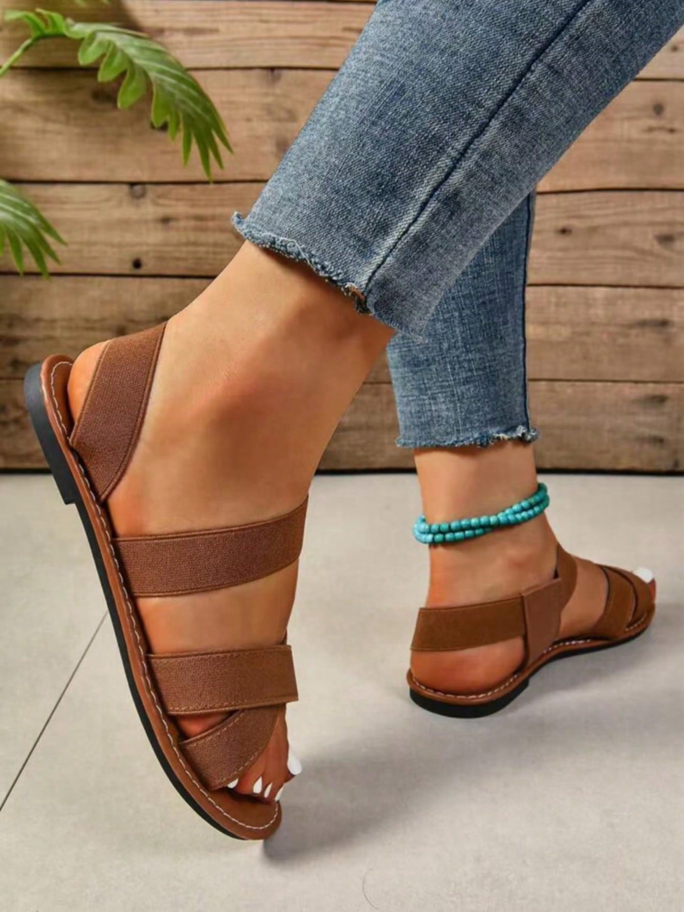 Women's flat thick sole gladiator sandals with cross adjustable straps and open toe, suitable for casual, vacation, and beach wear.