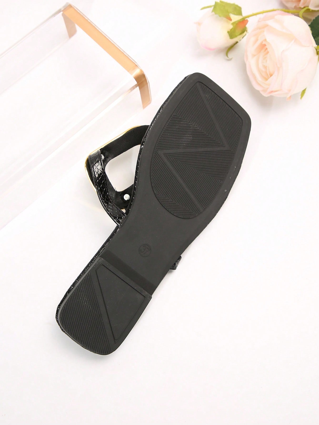 Black women's flat slide sandals with open toe design, decorated with pearl and rhinestone details.