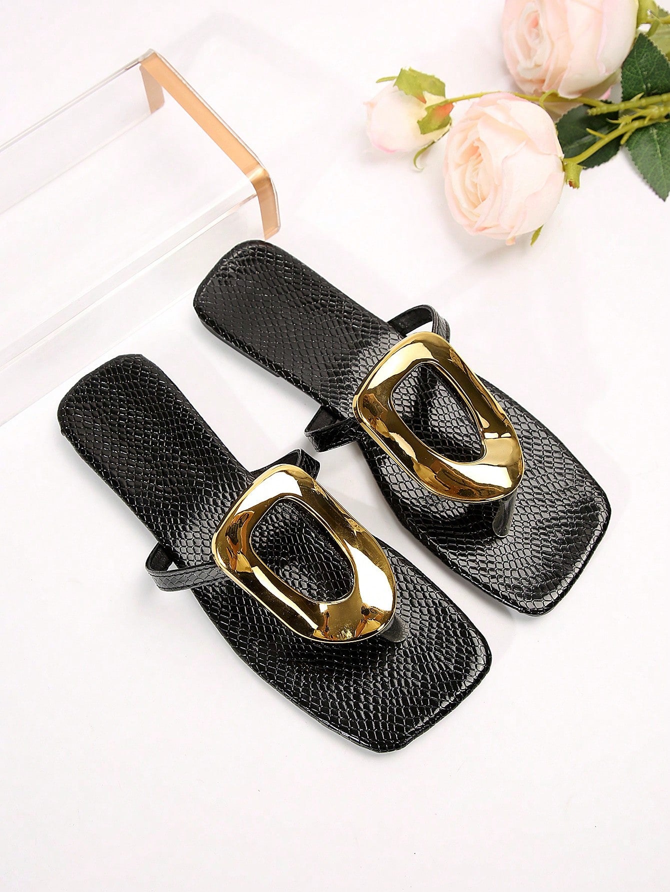 Black women's flat slide sandals with open toe design, decorated with pearl and rhinestone details.