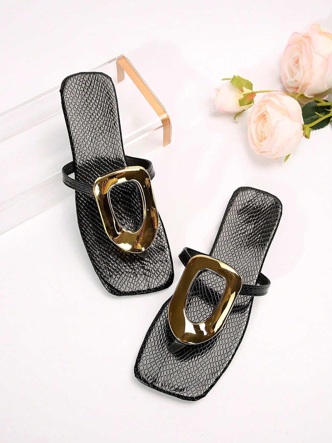 Black women's flat slide sandals with open toe design, decorated with pearl and rhinestone details.