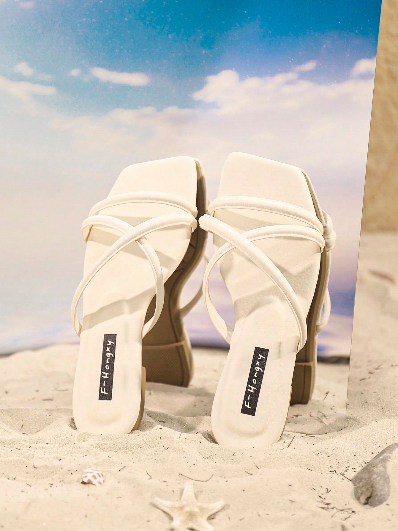 Women's slip-on flat slide sandals with bow tie decor, textured plain upper, and open toe.