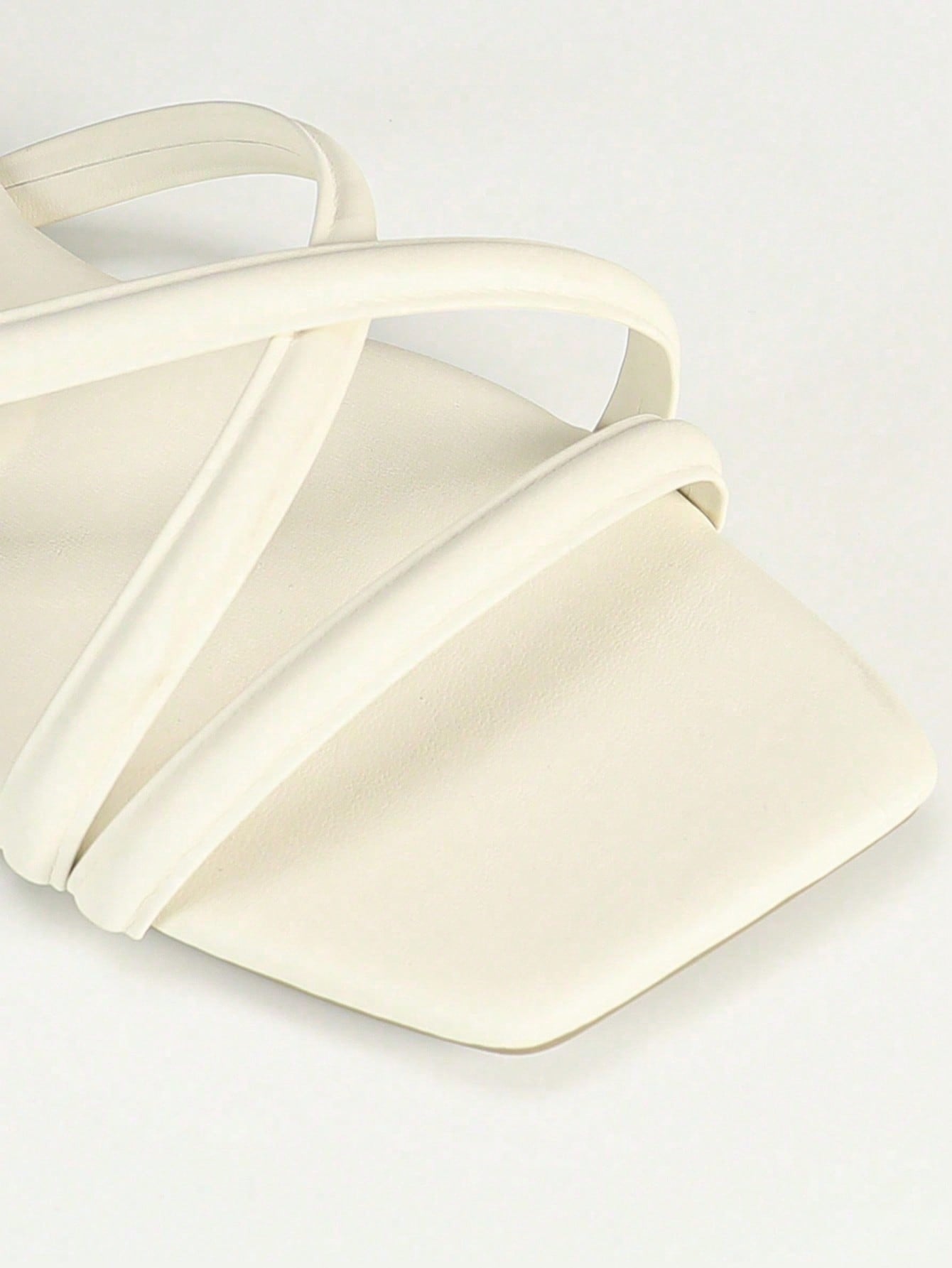 Women's slip-on flat slide sandals with bow tie decor, textured plain upper, and open toe.
