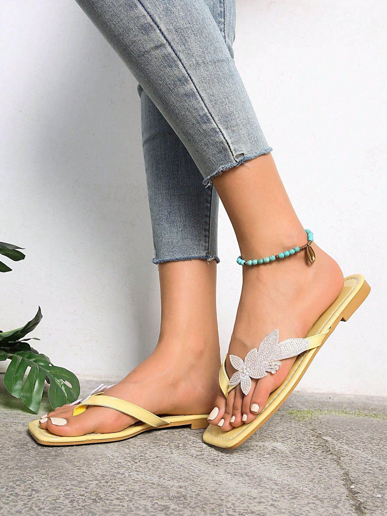 Plus size women's flat slide sandals featuring faux flower decor and a square toe, suitable for casual daily wear and beach use.