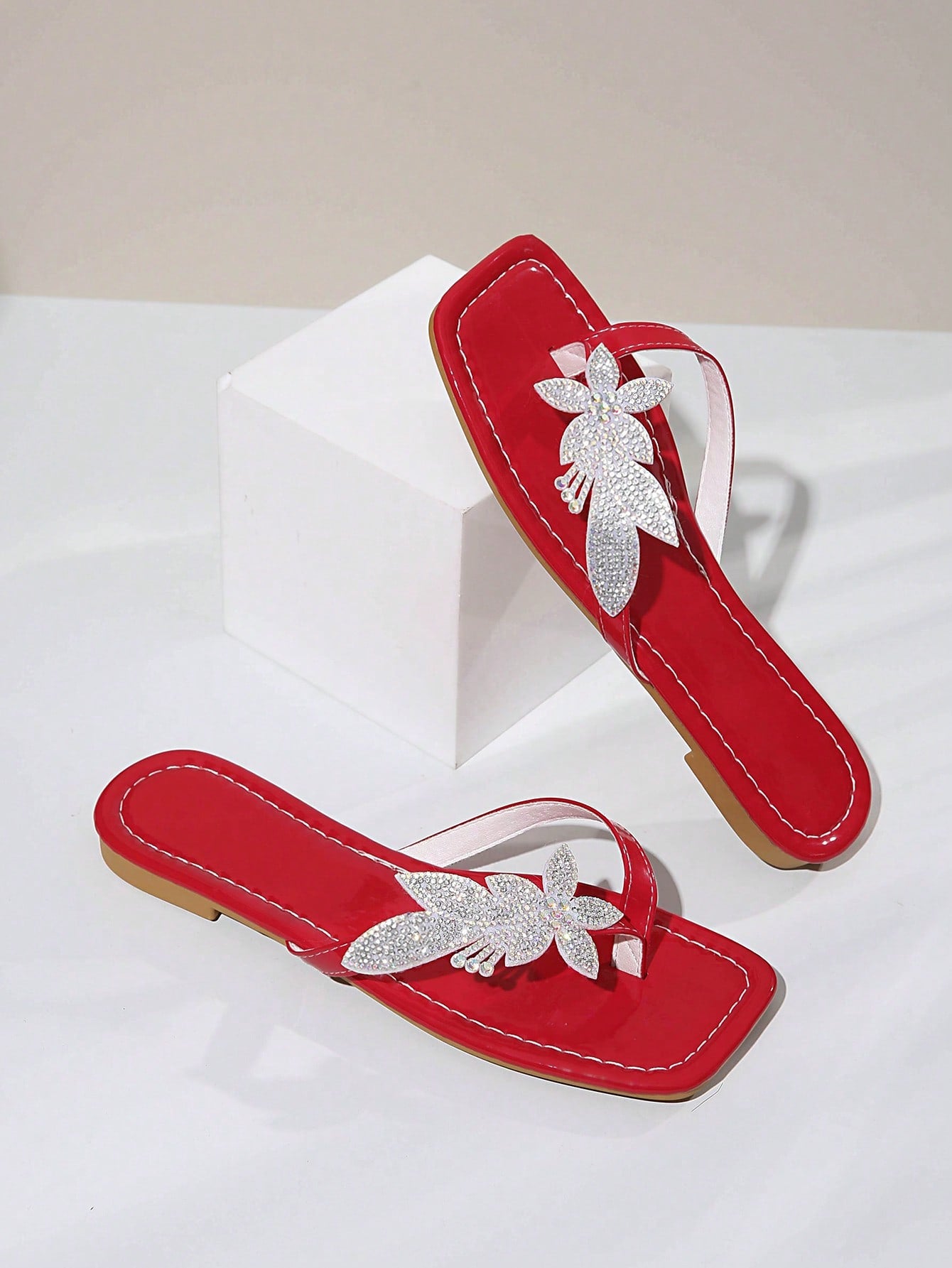 Plus size women's flat slide sandals featuring faux flower decor and a square toe, suitable for casual daily wear and beach use.