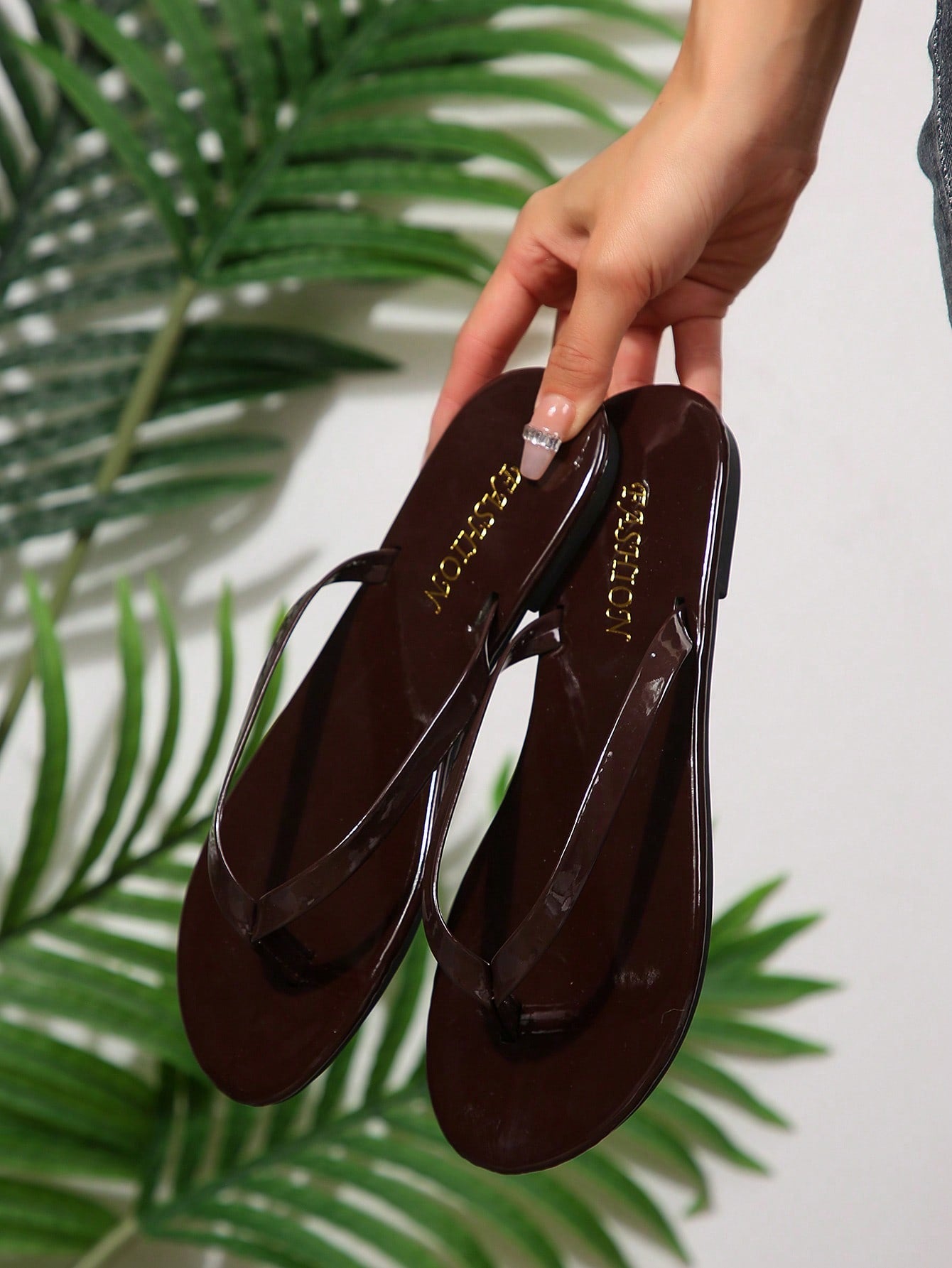 Women's chocolate brown flat flip flop sandals featuring a toe-post thong style and braided detail, suitable for casual indoor and outdoor wear.