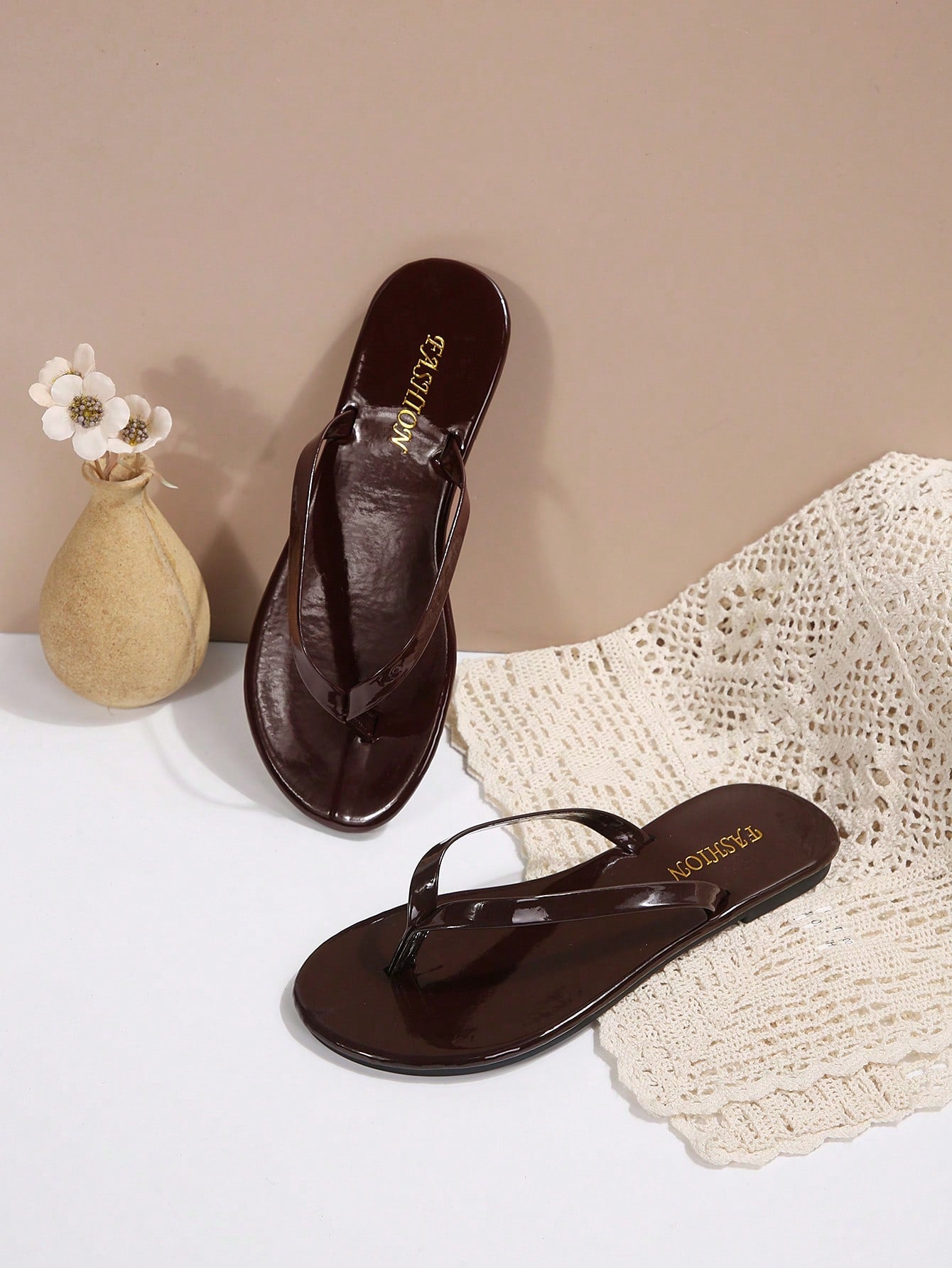 Women's chocolate brown flat flip flop sandals featuring a toe-post thong style and braided detail, suitable for casual indoor and outdoor wear.