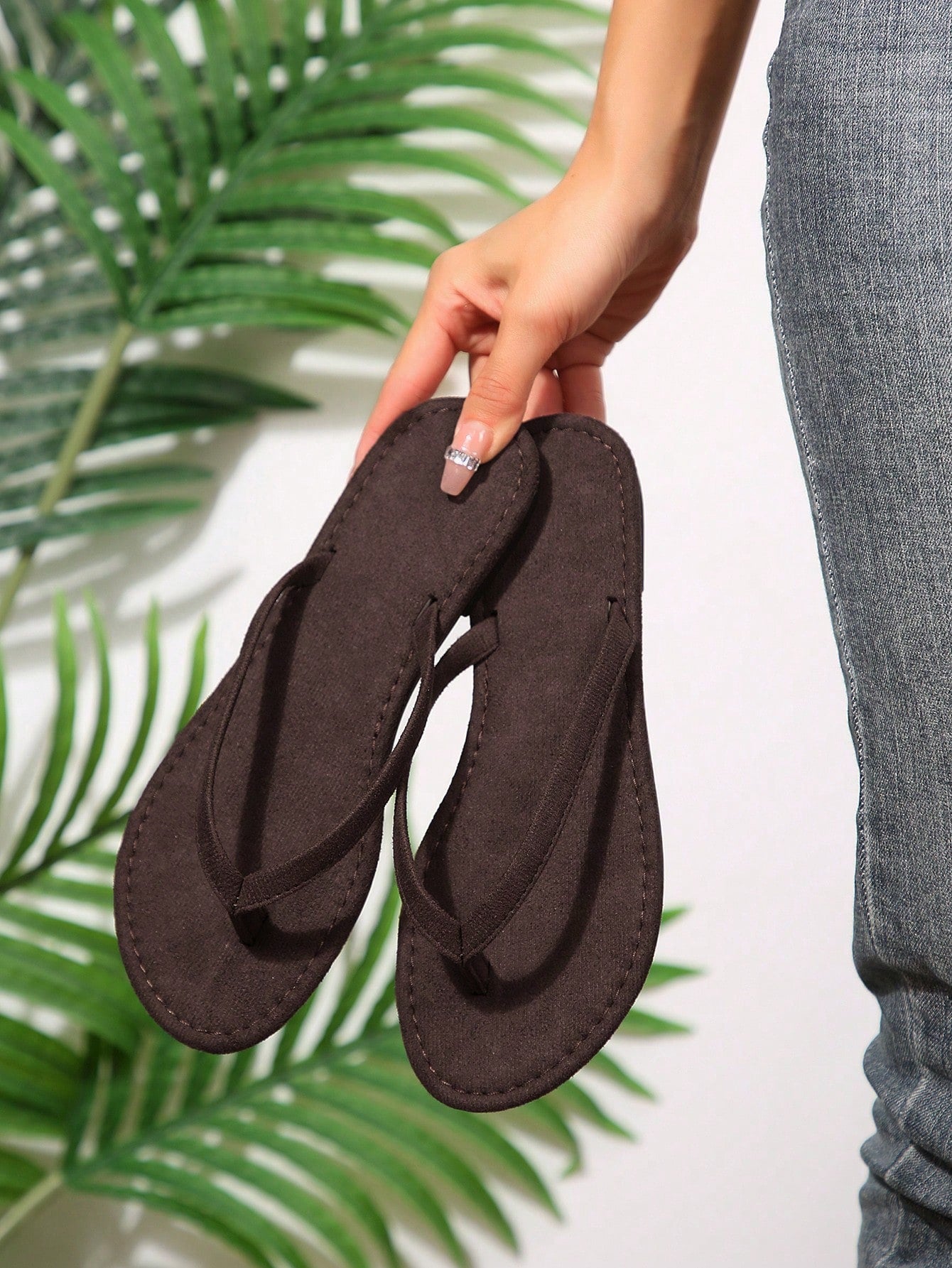 Women's chocolate brown flat flip flop sandals featuring a toe-post thong style and braided detail, suitable for casual indoor and outdoor wear.