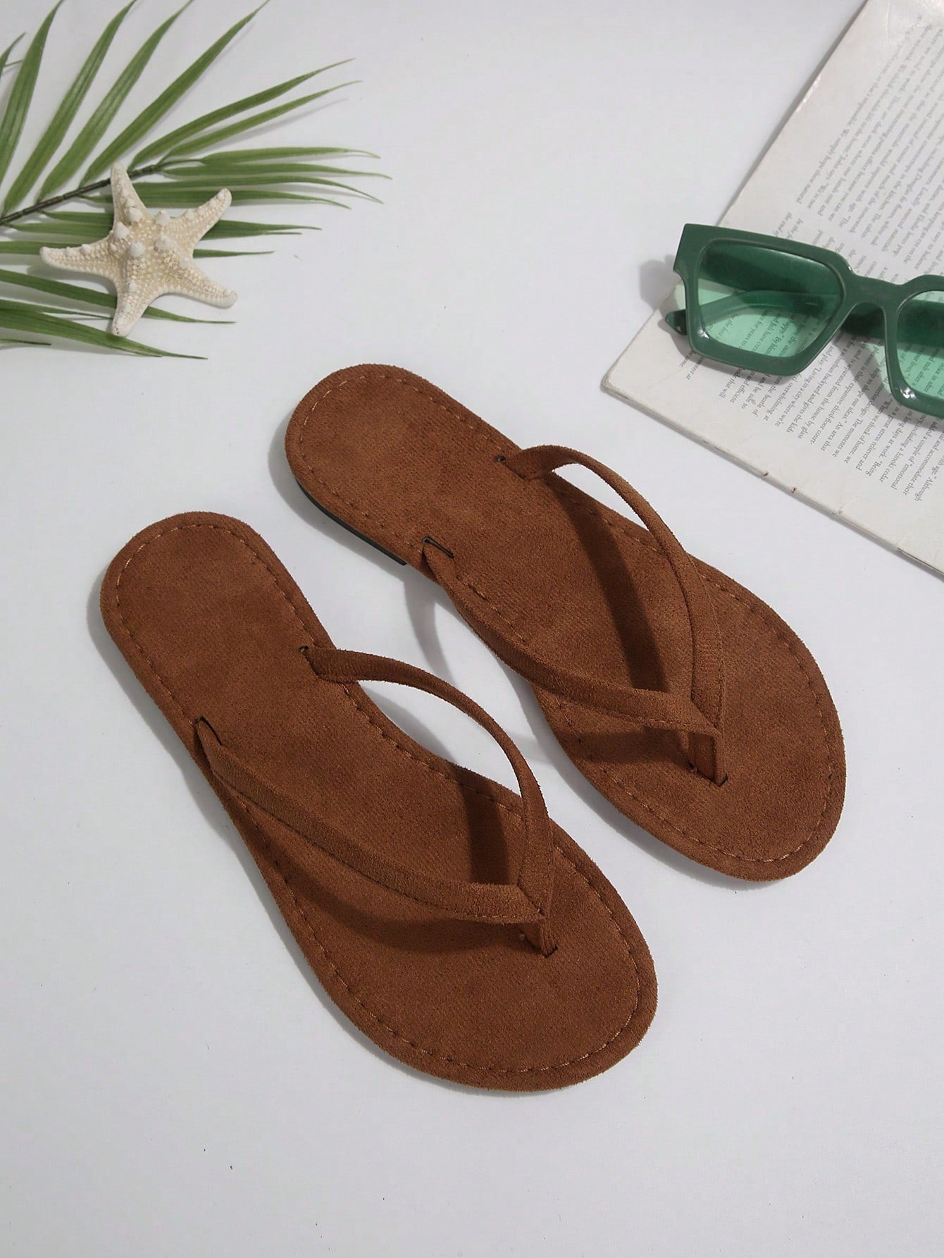 Women's chocolate brown flat flip flop sandals featuring a toe-post thong style and braided detail, suitable for casual indoor and outdoor wear.
