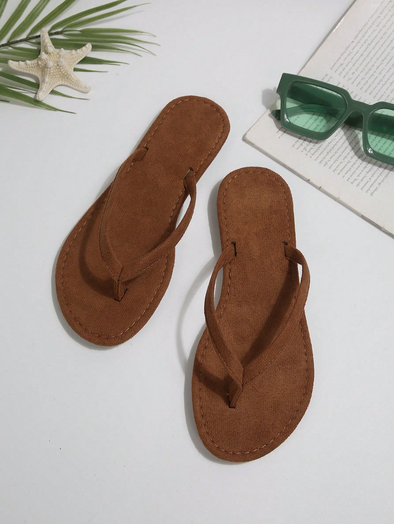 Women's chocolate brown flat flip flop sandals featuring a toe-post thong style and braided detail, suitable for casual indoor and outdoor wear.