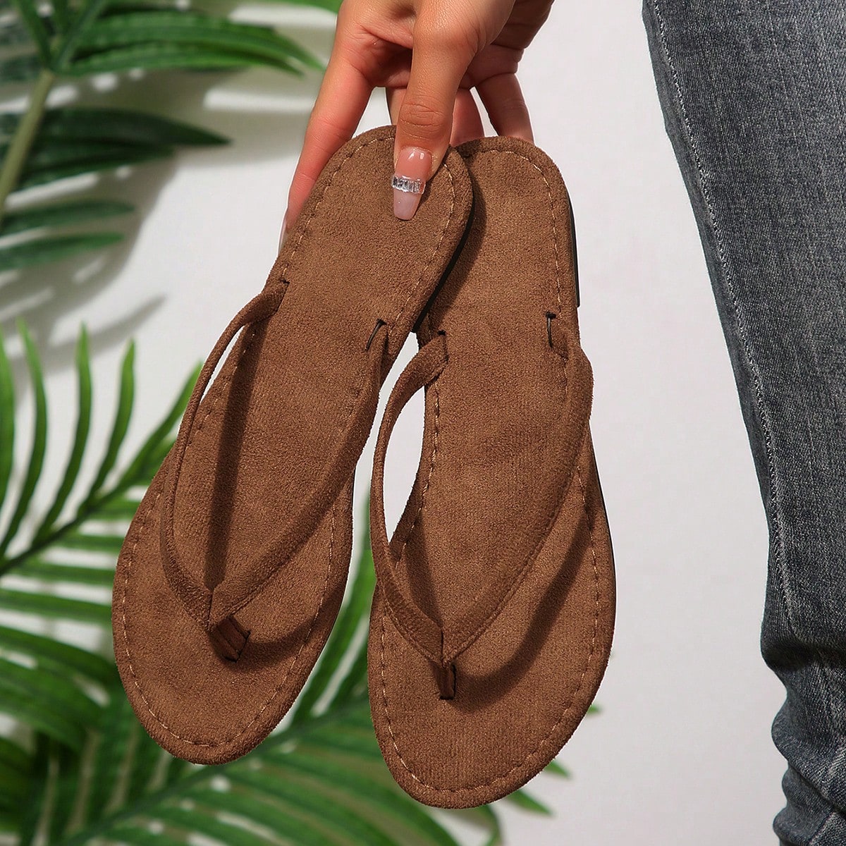 Women's chocolate brown flat flip flop sandals featuring a toe-post thong style and braided detail, suitable for casual indoor and outdoor wear.