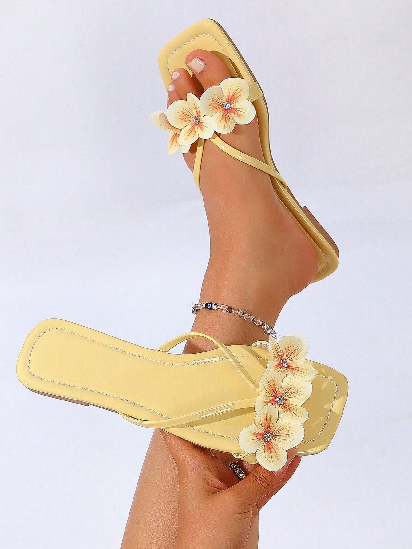 Women's khaki flat slide sandals with open toe, bow tie detail, and floral plant-pattern vacation style design.