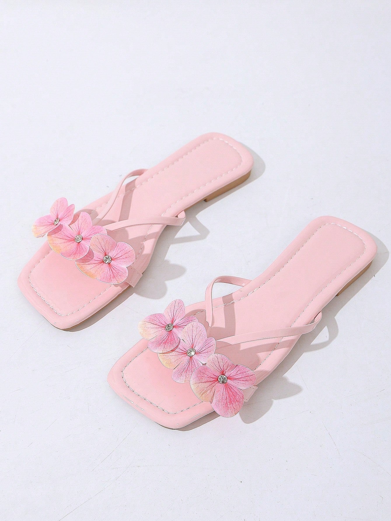 Women's khaki flat slide sandals with open toe, bow tie detail, and floral plant-pattern vacation style design.