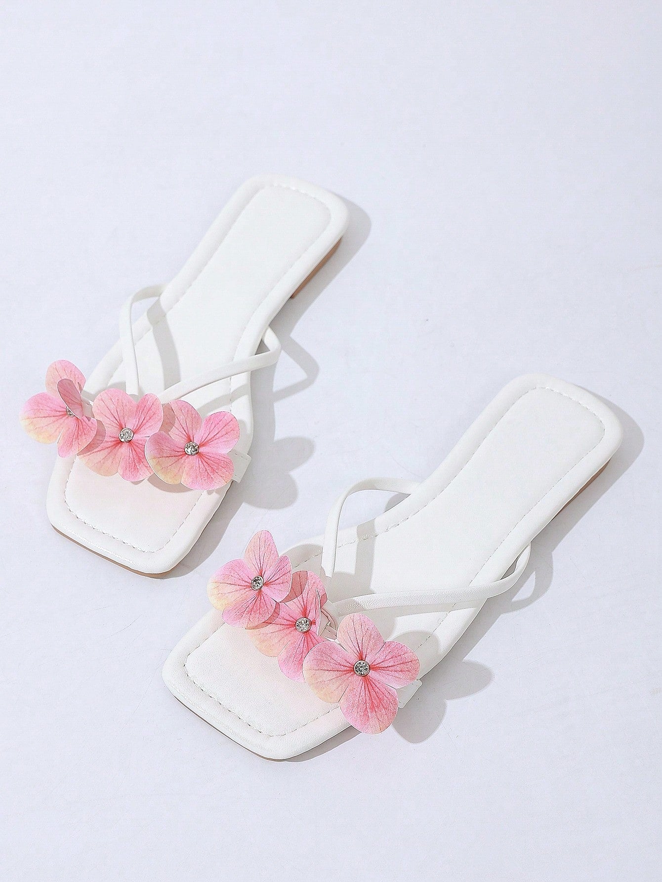 Women's khaki flat slide sandals with open toe, bow tie detail, and floral plant-pattern vacation style design.