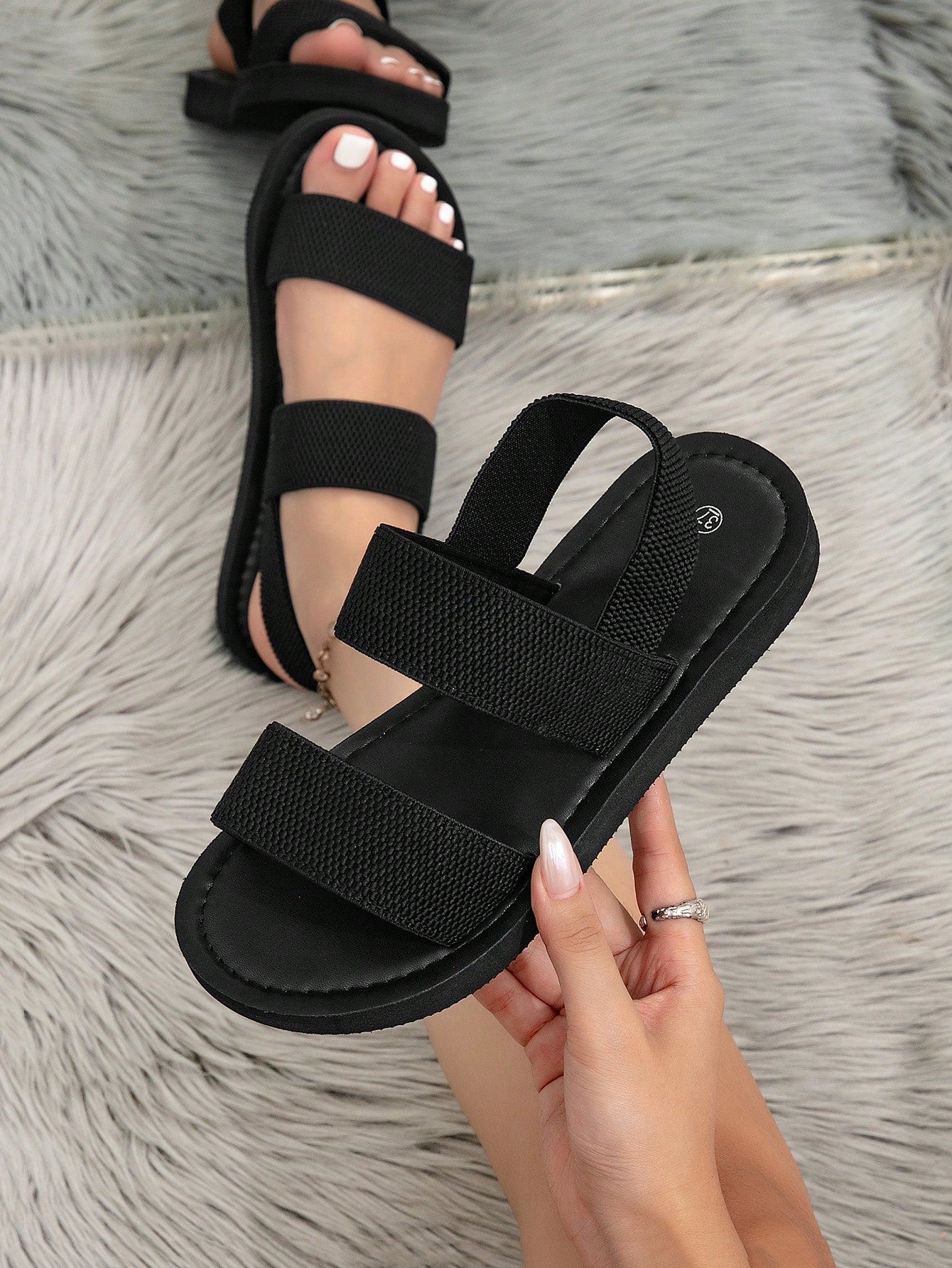 Women's flat slide sandals with ruched fabric, bow accent, and fringe detail, suitable for outdoor vacation wear.