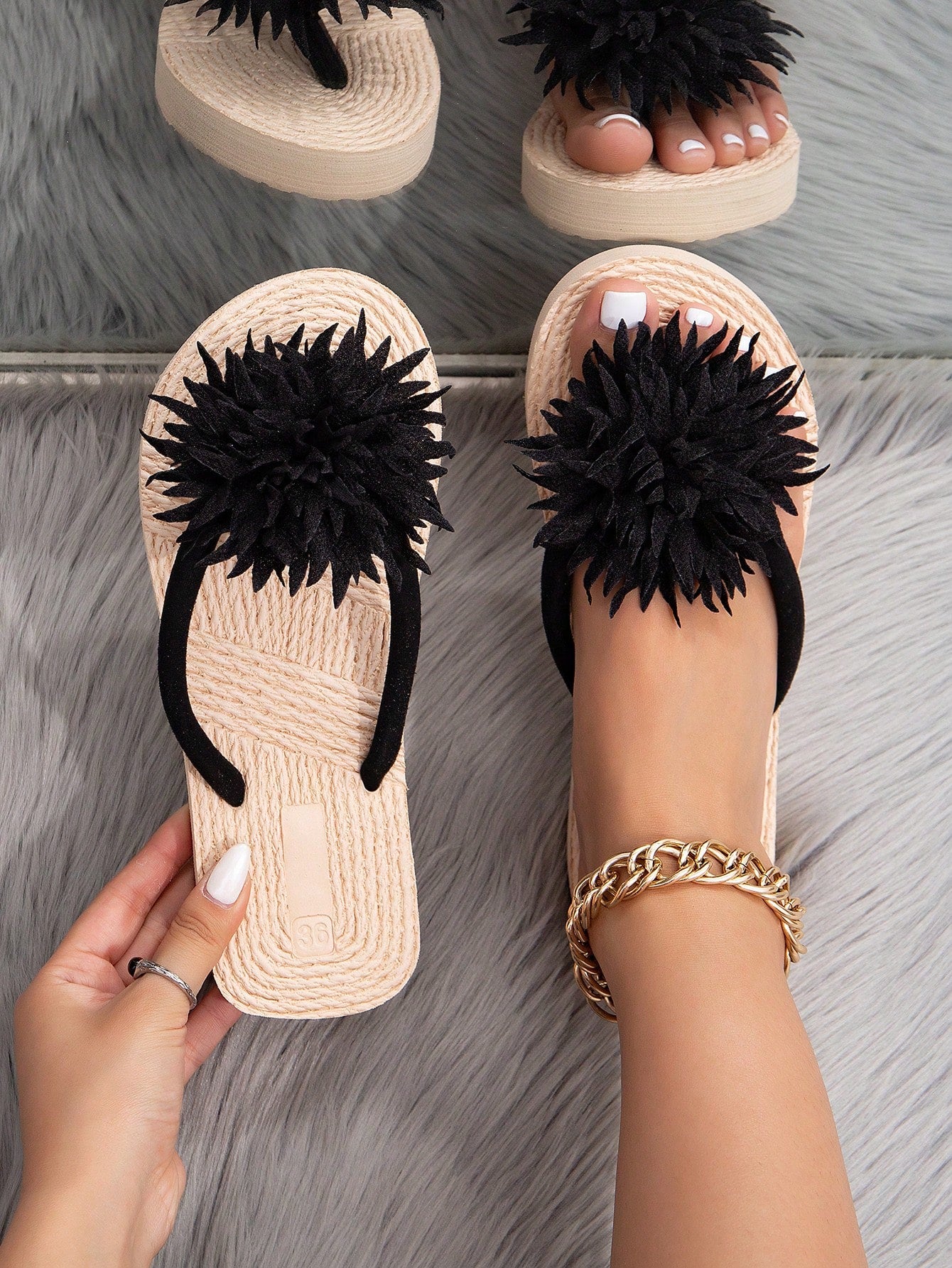 Women's woven-style flat beach flip-flop sandals with black peony applique decoration and casual design