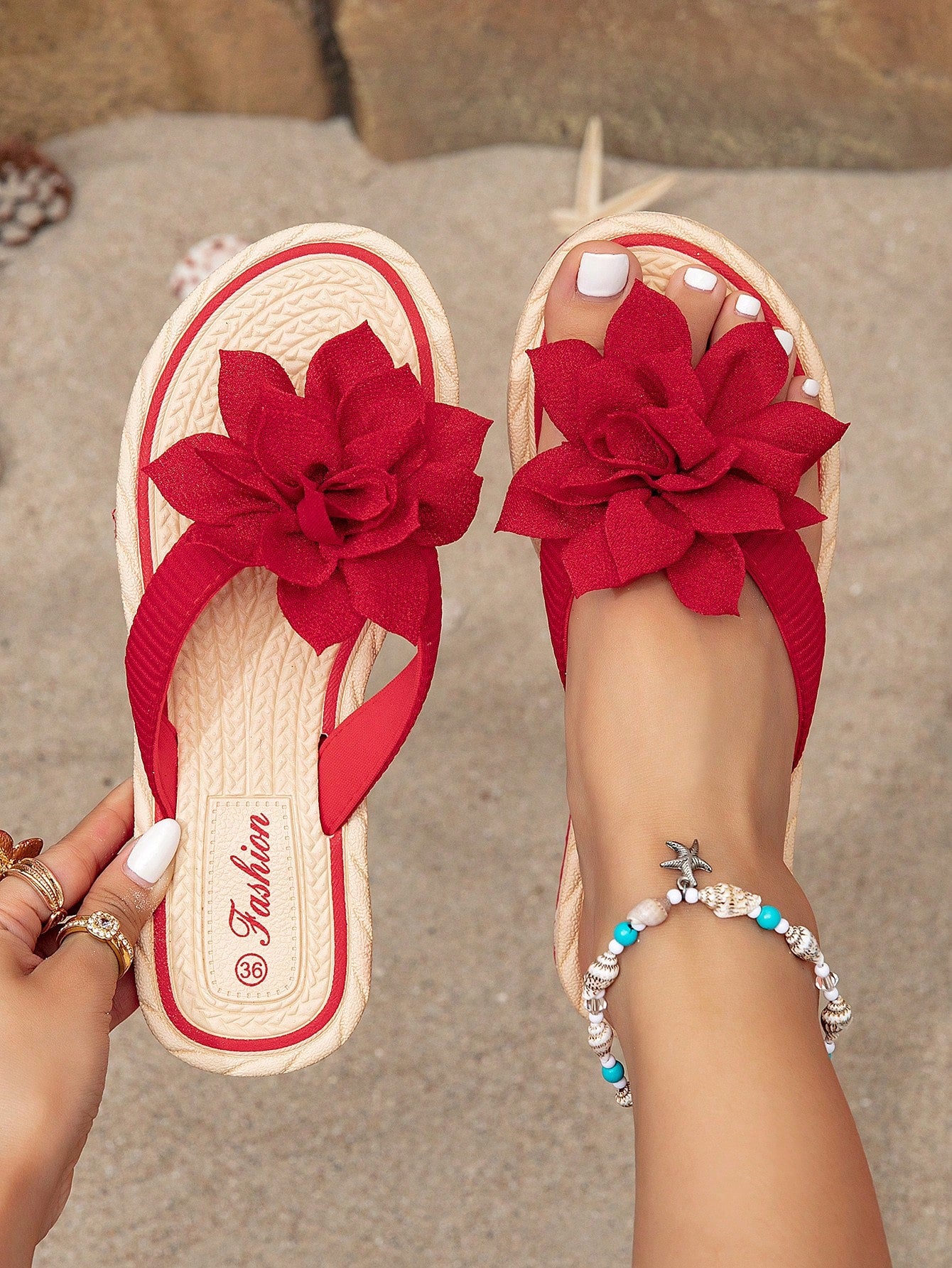 Women's woven-style flat beach flip-flop sandals with black peony applique decoration and casual design