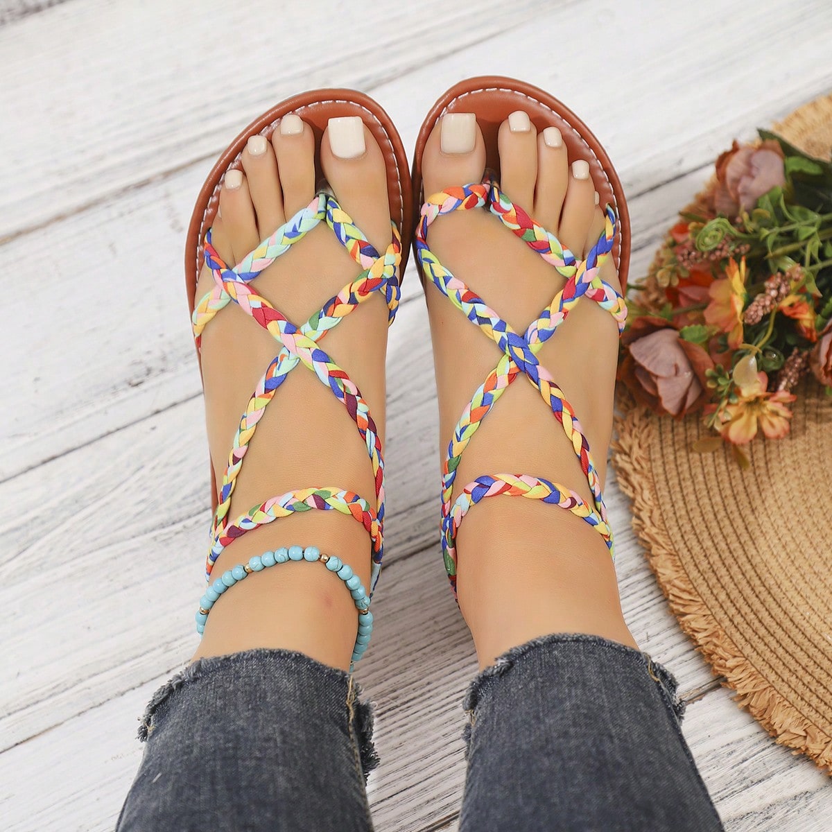 Women's woven criss-cross elastic flat sandals with braided strappy upper and toe post design