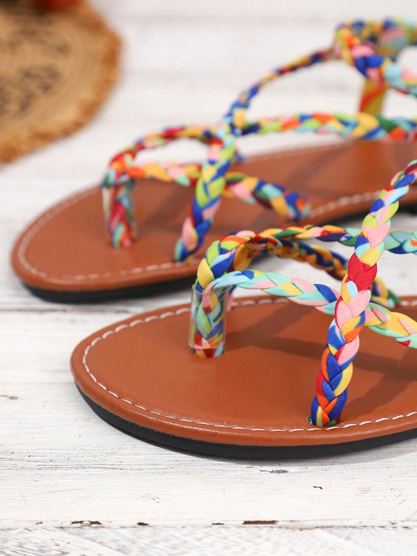 Women's woven criss-cross elastic flat sandals with braided strappy upper and toe post design