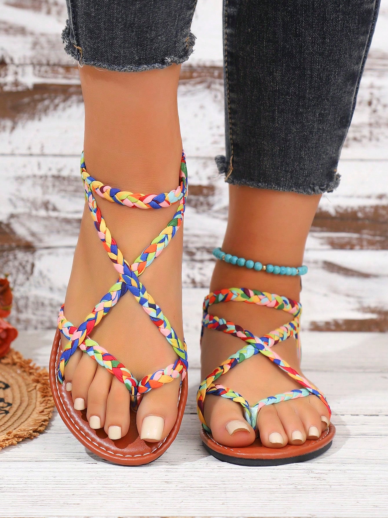 Women's woven criss-cross elastic flat sandals with braided strappy upper and toe post design