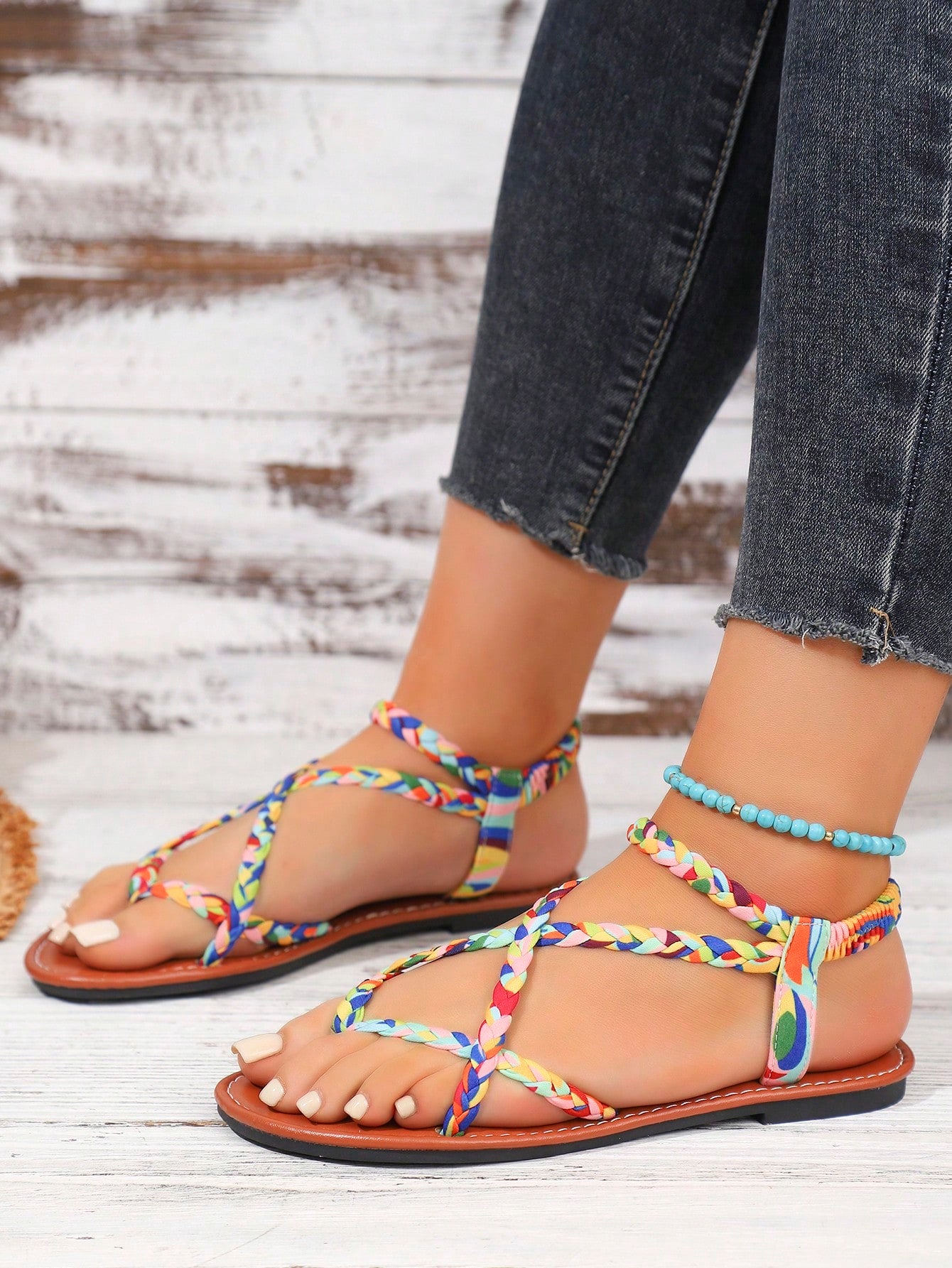 Women's woven criss-cross elastic flat sandals with braided strappy upper and toe post design