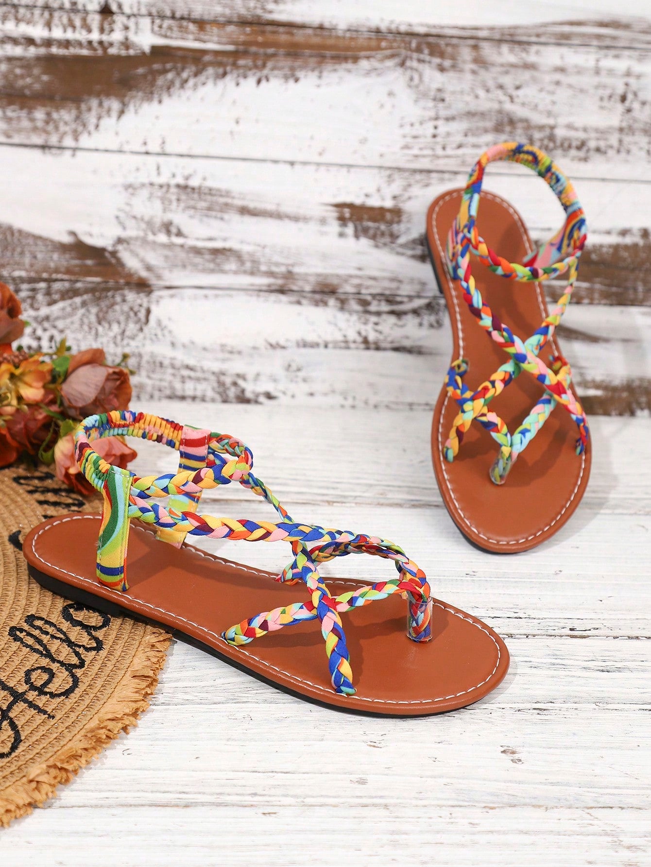 Women's woven criss-cross elastic flat sandals with braided strappy upper and toe post design