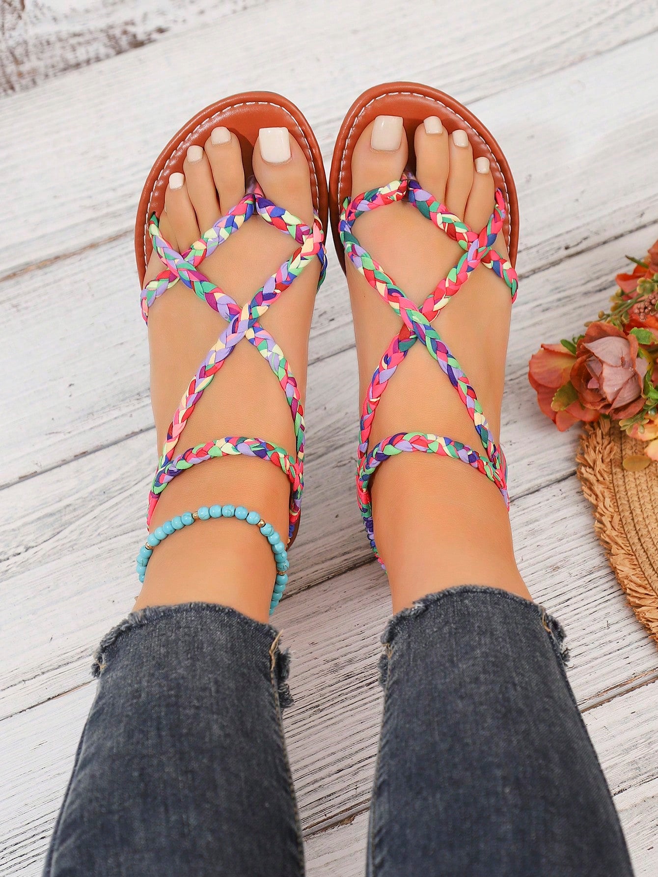 Women's woven criss-cross elastic flat sandals with braided strappy upper and toe post design