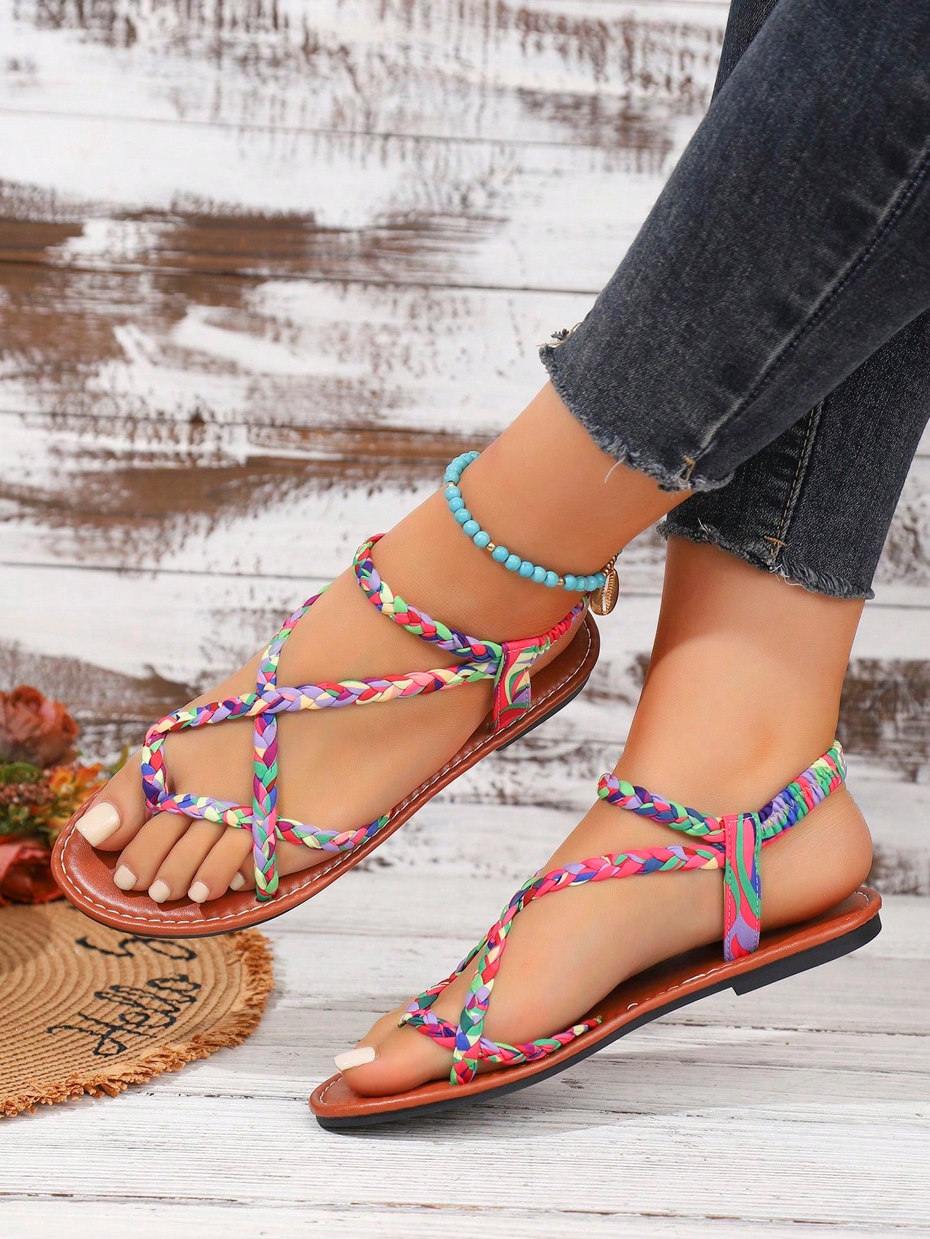 Women's woven criss-cross elastic flat sandals with braided strappy upper and toe post design