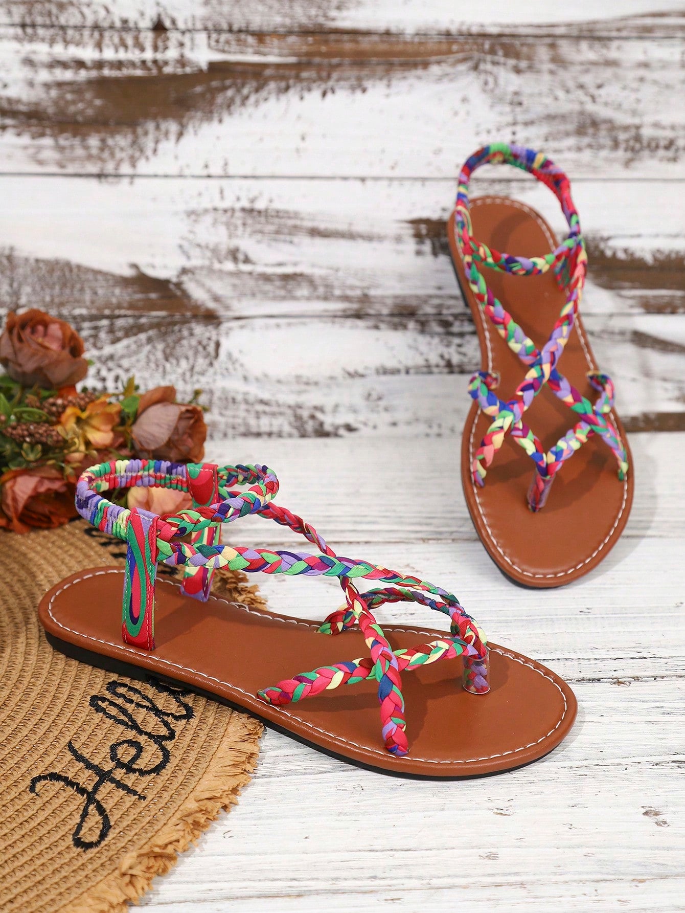 Women's woven criss-cross elastic flat sandals with braided strappy upper and toe post design