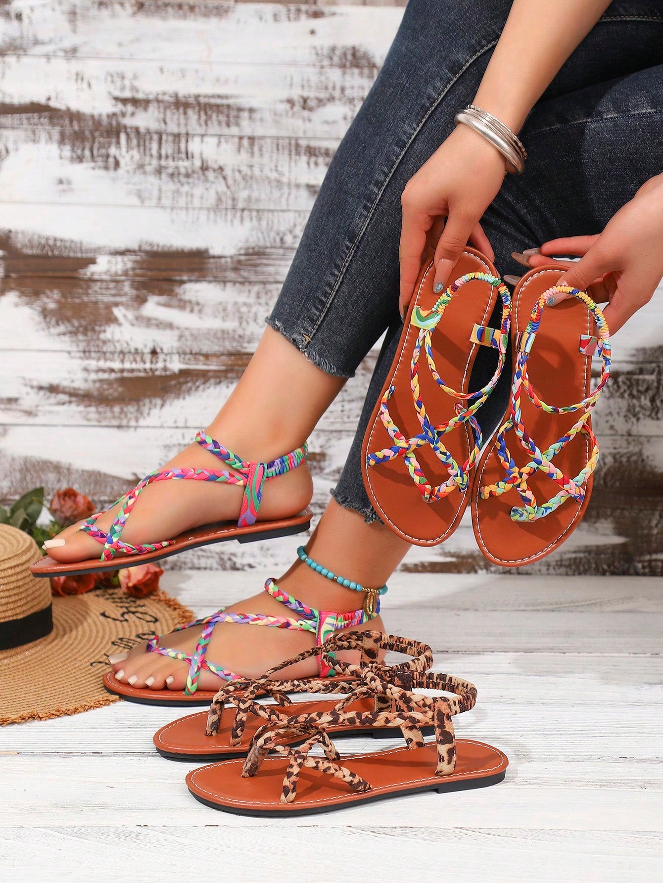 Women's woven criss-cross elastic flat sandals with braided strappy upper and toe post design