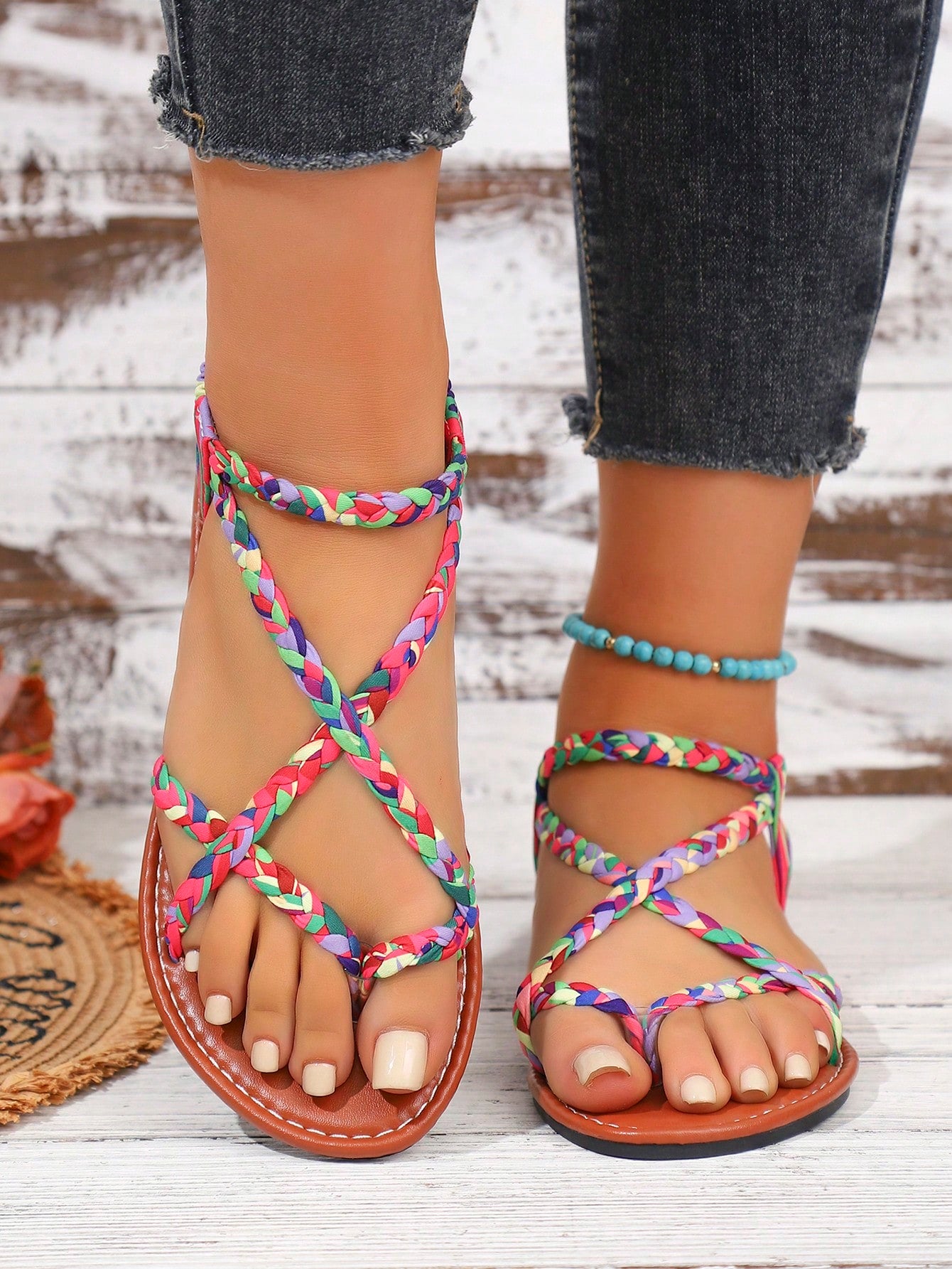 Women's woven criss-cross elastic flat sandals with braided strappy upper and toe post design