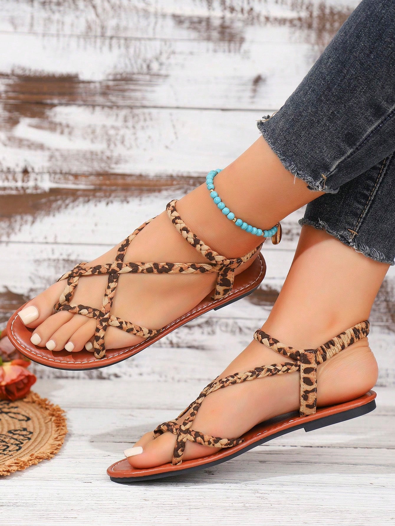 Women's woven criss-cross elastic flat sandals with braided strappy upper and toe post design