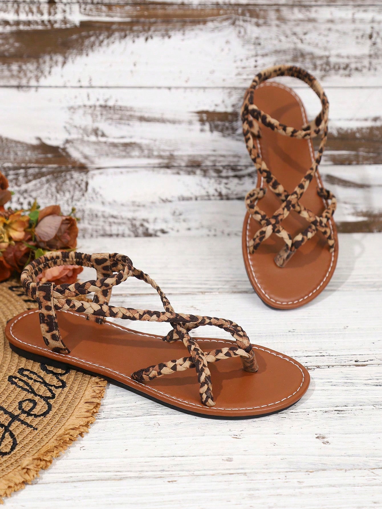 Women's woven criss-cross elastic flat sandals with braided strappy upper and toe post design
