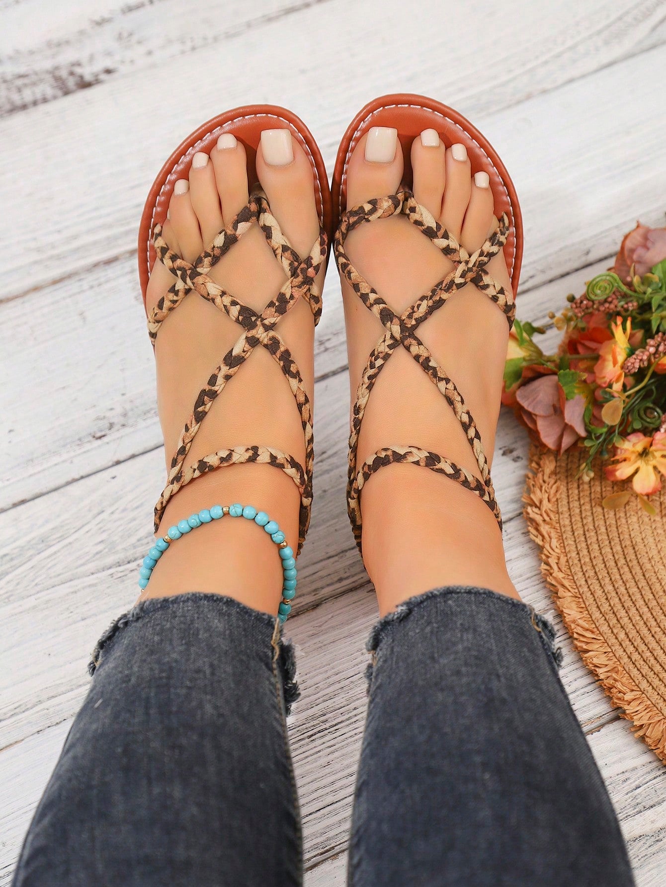 Women's woven criss-cross elastic flat sandals with braided strappy upper and toe post design