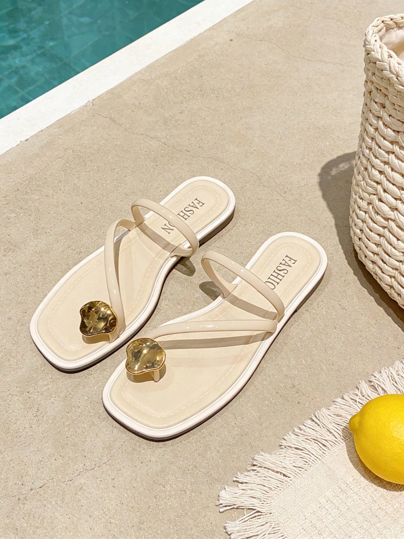 Women's white flat slide sandals featuring criss cross straps, shell detail, and buckle accents