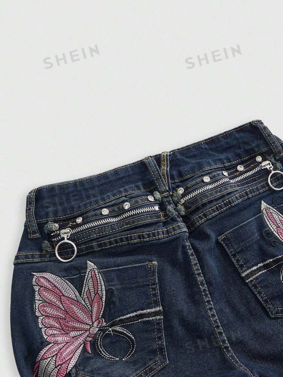 Blue washed shorts with butterfly embroidery, distressed detailing, ultra low waist, button closure, zipper fly, and pockets.