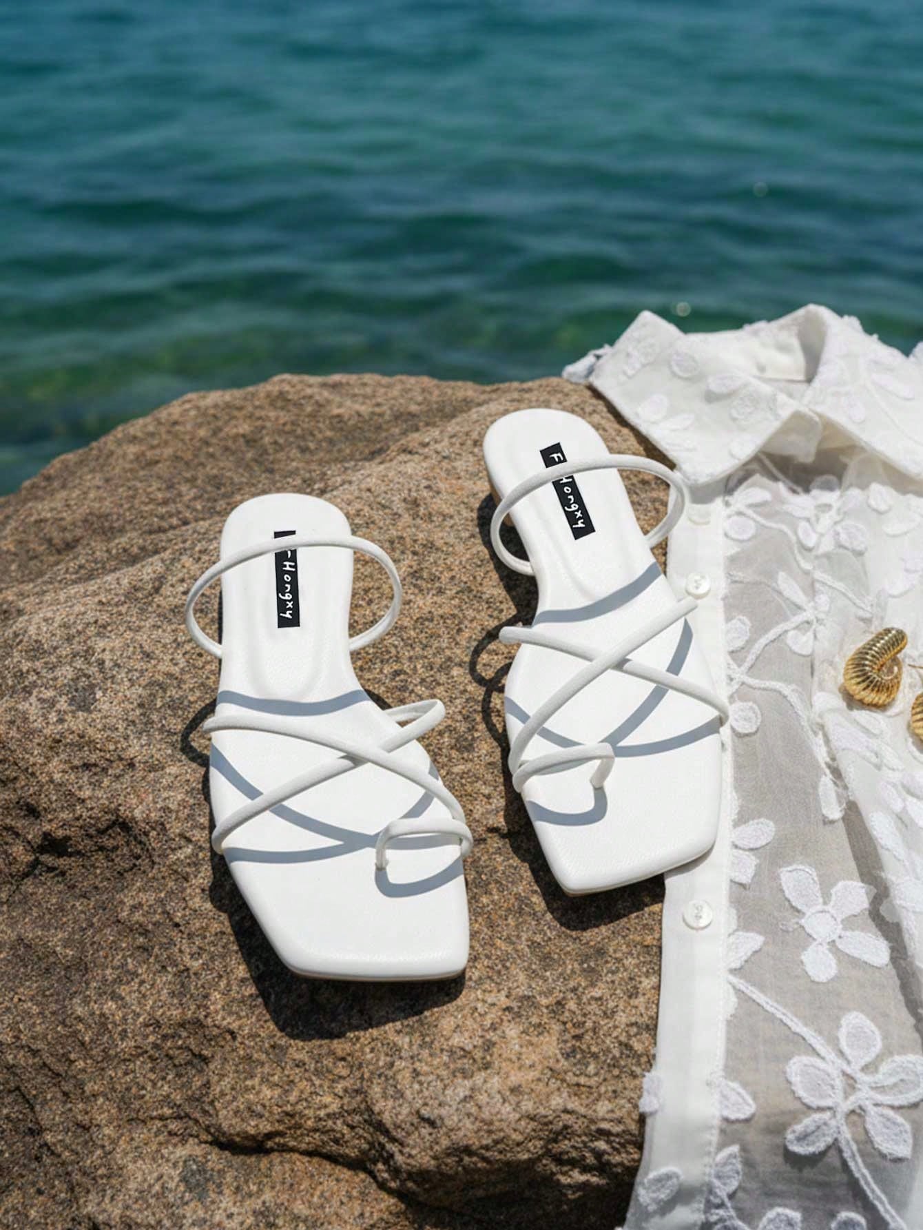 Women's slip-on flat slide sandals with bow tie decor, textured plain upper, and open toe.