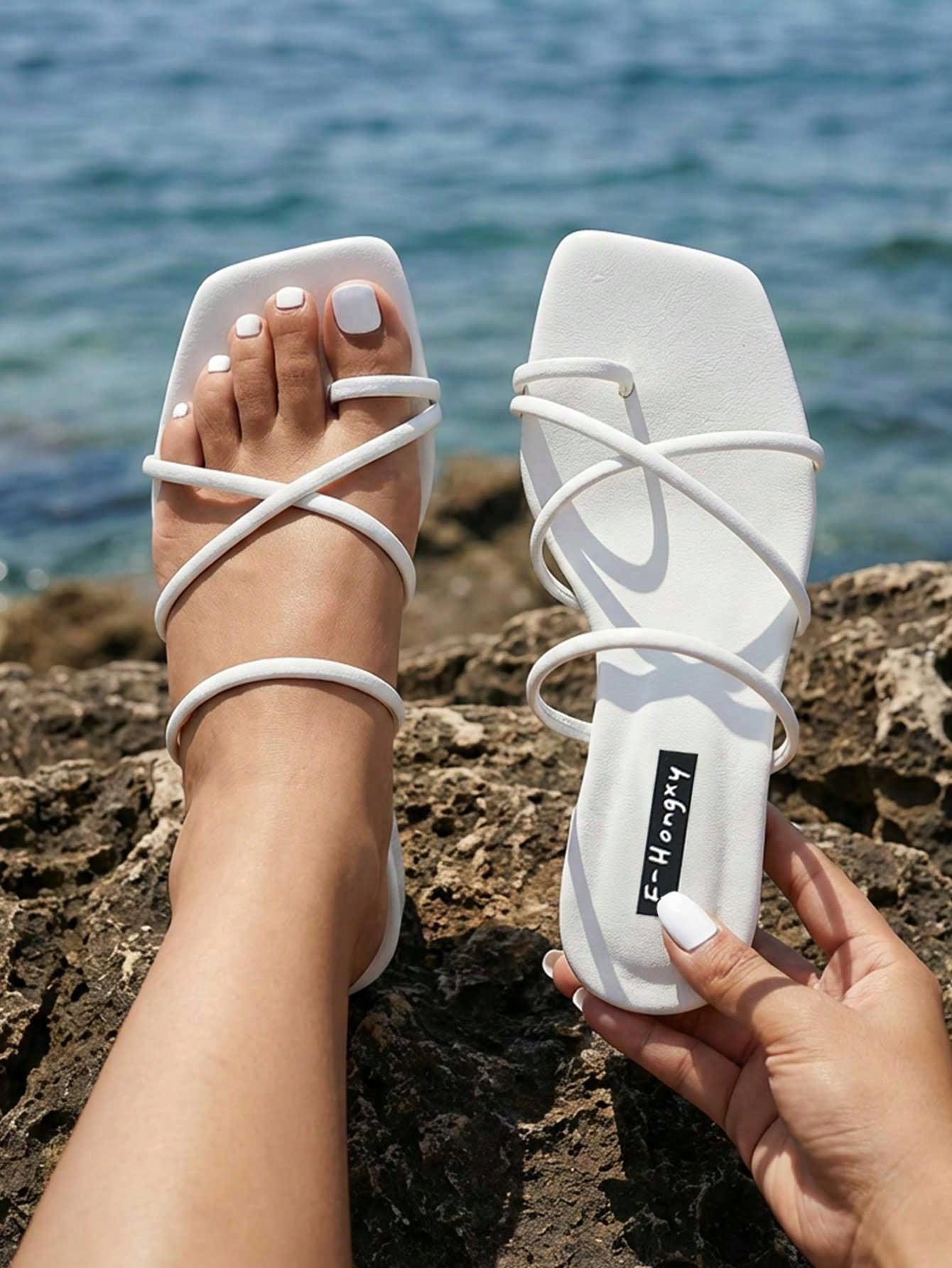 Women's slip-on flat slide sandals with bow tie decor, textured plain upper, and open toe.
