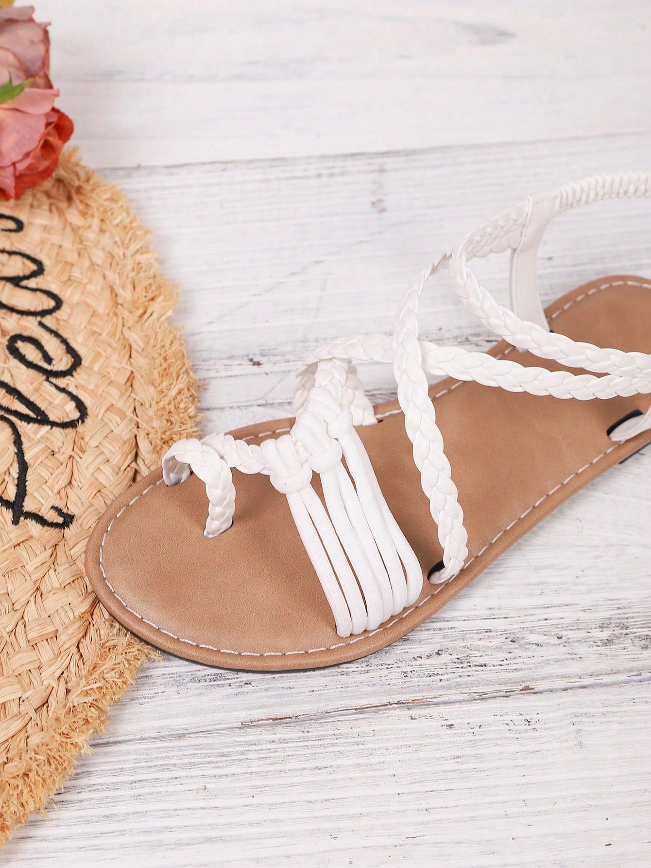 Women's woven criss-cross elastic flat sandals with braided strappy upper and toe post design