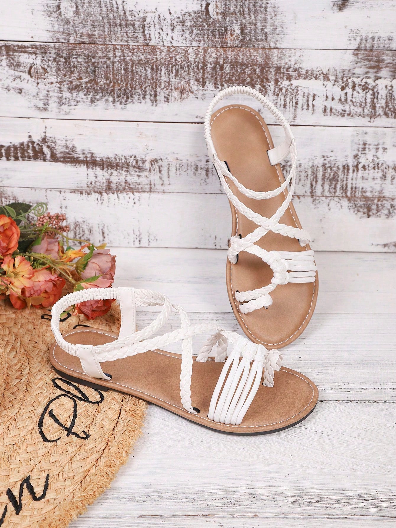 Women's woven criss-cross elastic flat sandals with braided strappy upper and toe post design