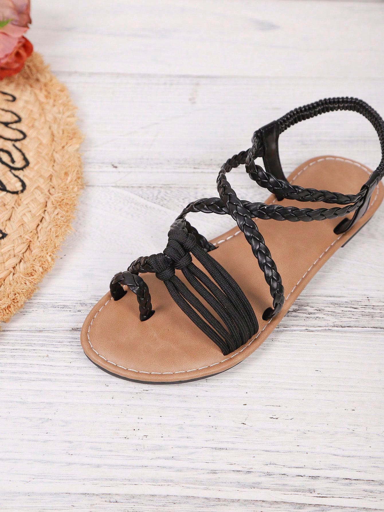 Women's woven criss-cross elastic flat sandals with braided strappy upper and toe post design