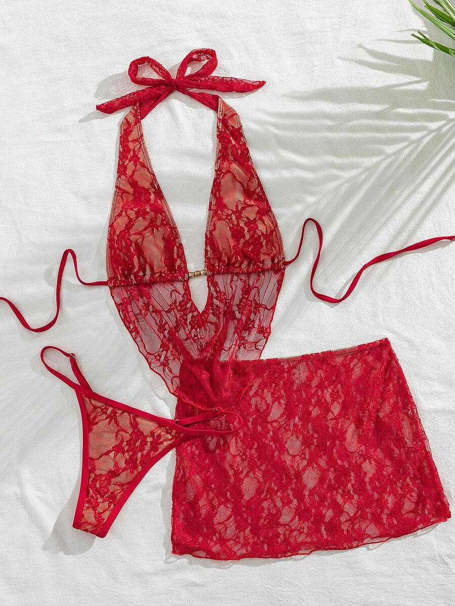 Women's black 3-piece bikini set with halter triangle top, backless design, ruched thong bottoms, and matching lace skirt for beach or vacation wear.
