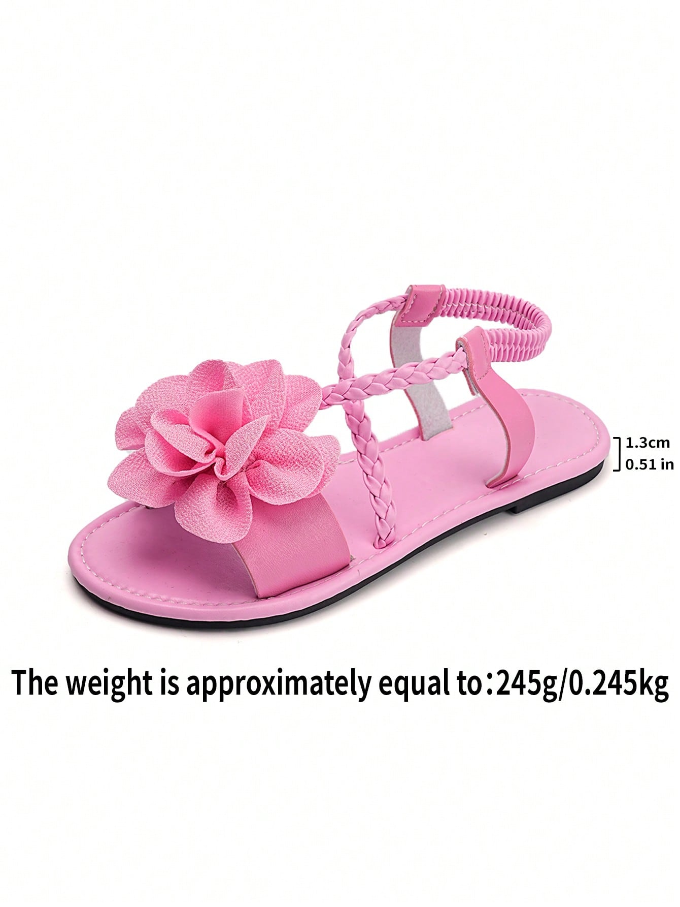 Women's open-toe flat slide sandals with crossed woven-look straps, floral appliqué detail, and buckle accent, shown in a casual beach style.