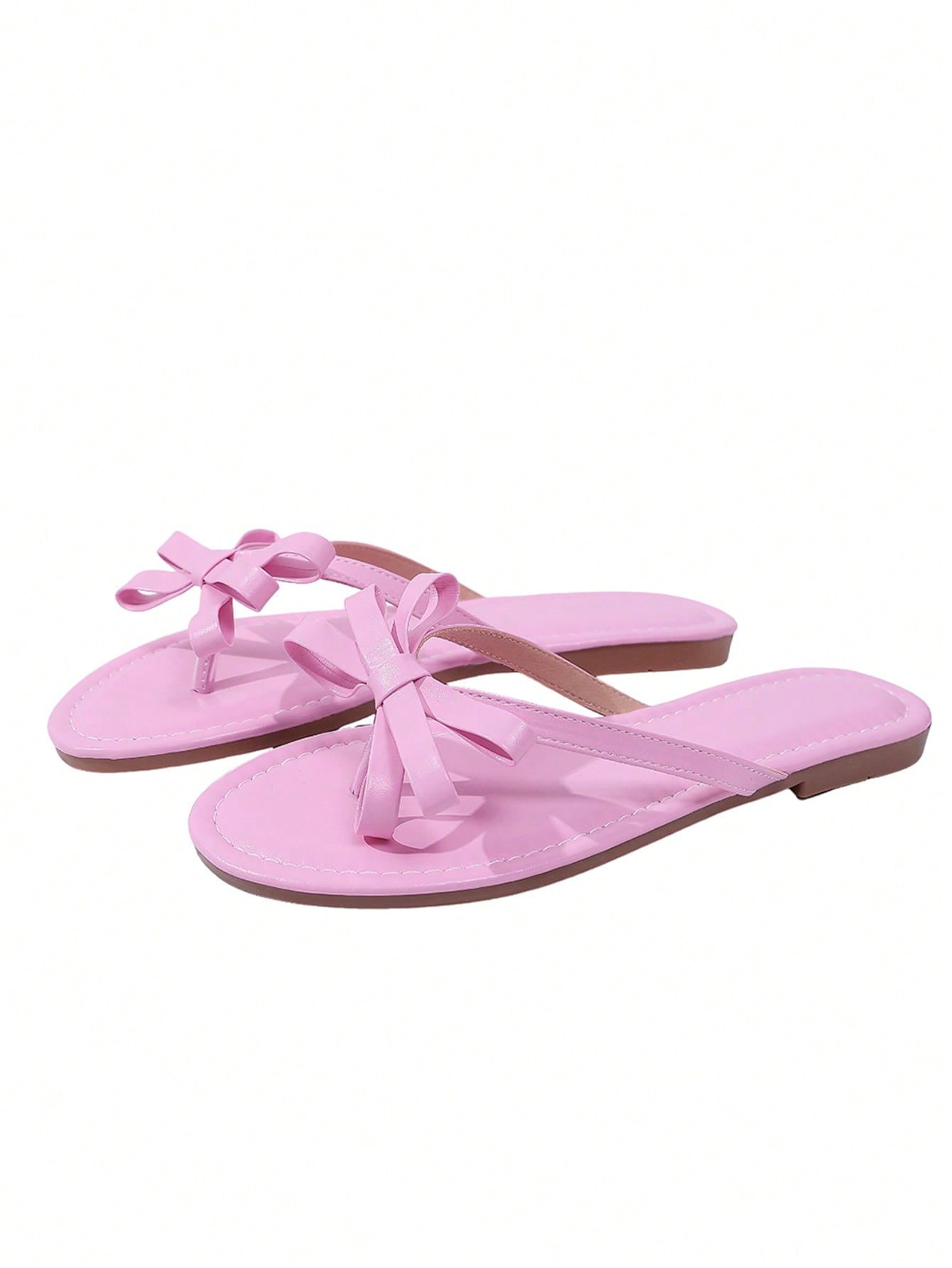 Women’s flat slide sandals with contrast mesh bow decoration and textured upper, open toe design, and slip-on style for beach and vacation wear.