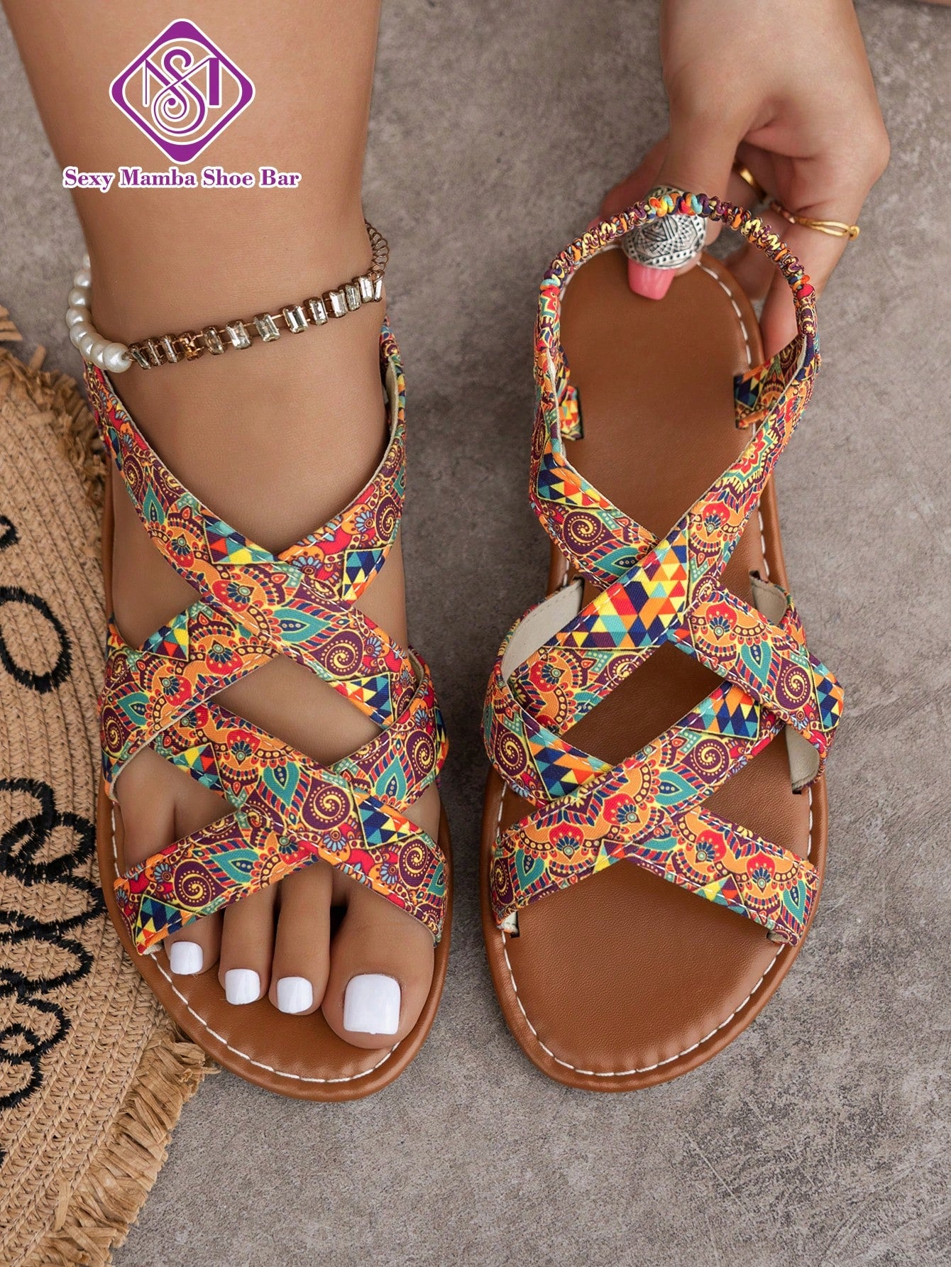 Women's wide fit flat slip-on sandals with criss-cross straps and open toe, designed for casual outdoor and beach wear.