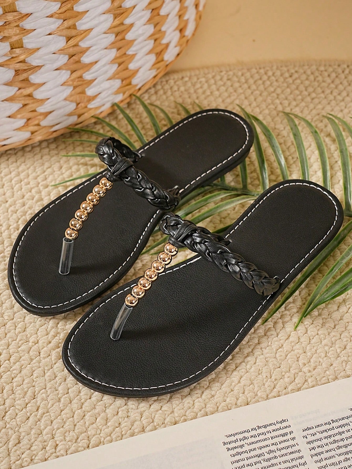 Women's black strappy flip flops with geometric pattern and star detail, flat heel, slip-on style, suitable for beach, indoor, and outdoor walking.