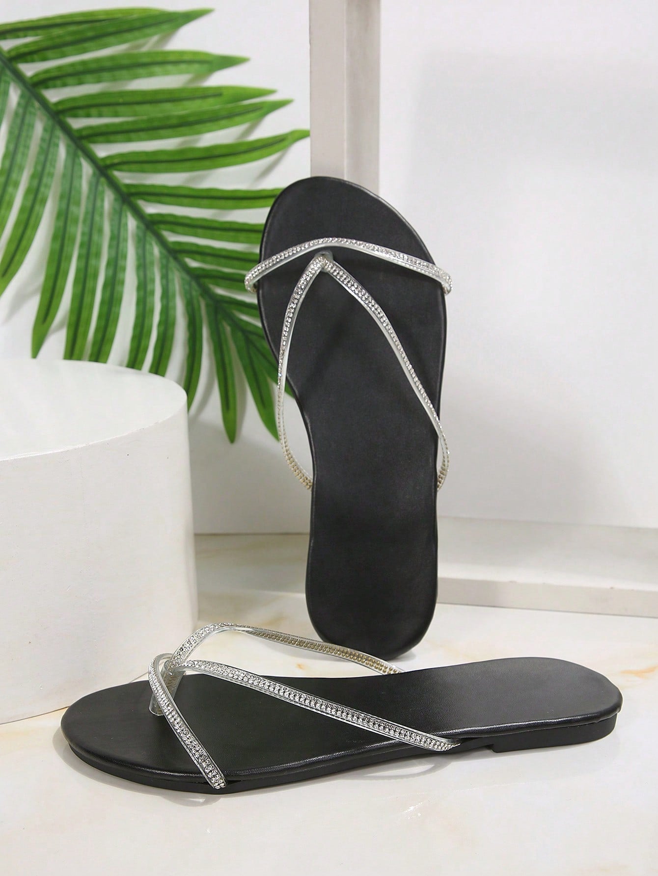 Plus size women's black flat thong sandals with rhinestone detail, round open toe, and slip-on beach-style design