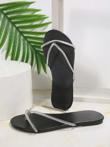 Plus size women's black flat thong sandals with rhinestone detail, round open toe, and slip-on beach-style design